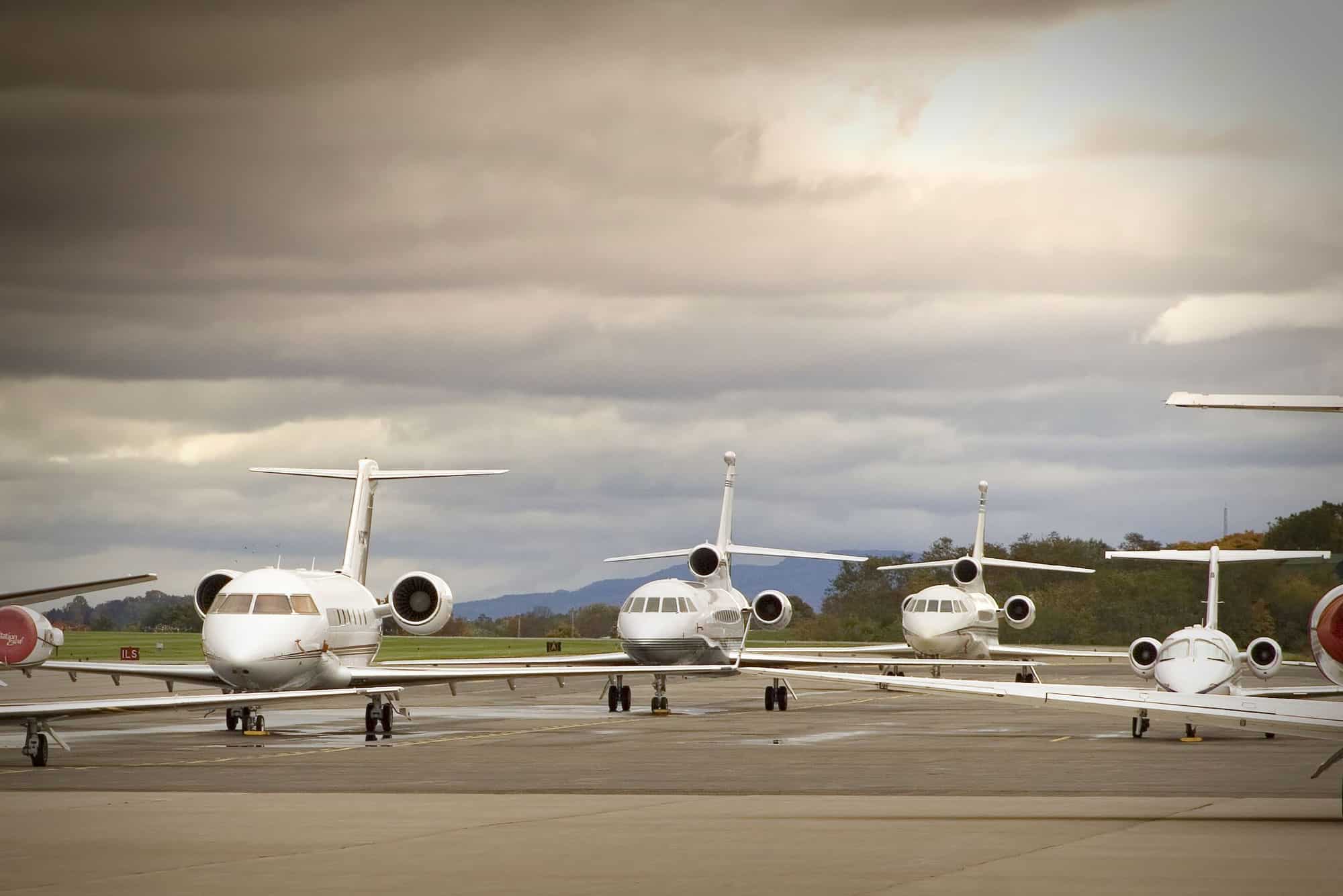 several private jets on tarmac